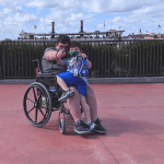 Teen boy with Chiari malformation with younger brother entering Disney