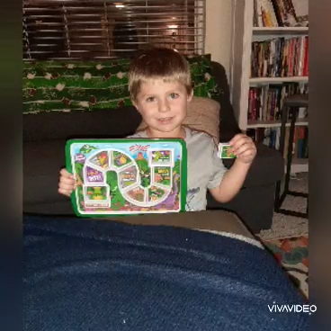 Boy with hearing loss holding electronic learning toy