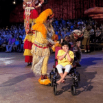 Girl in wheelchair participating in Animal Kingdom's Lion King show