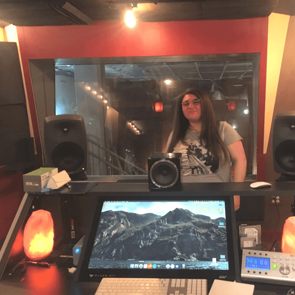 Teen girl learns how to record music at studio