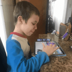 10-year-old boy with low-functioning autism enjoys his new iPad