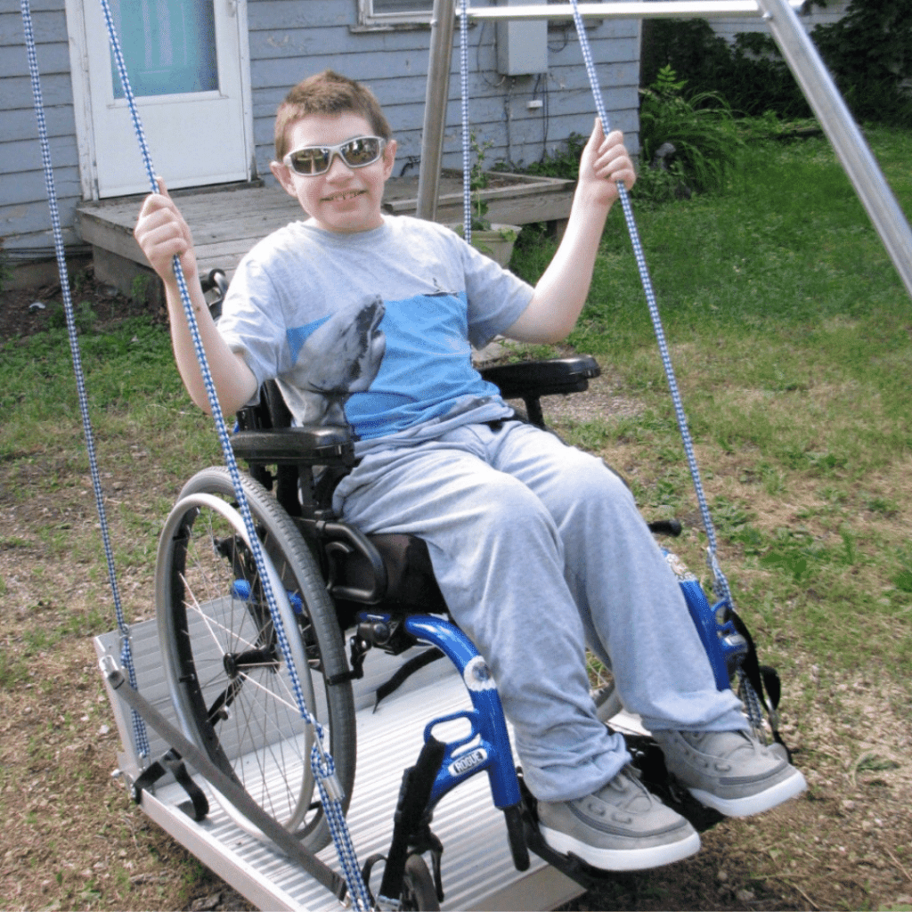 Teen boy enjoying backyard wheelchair swing