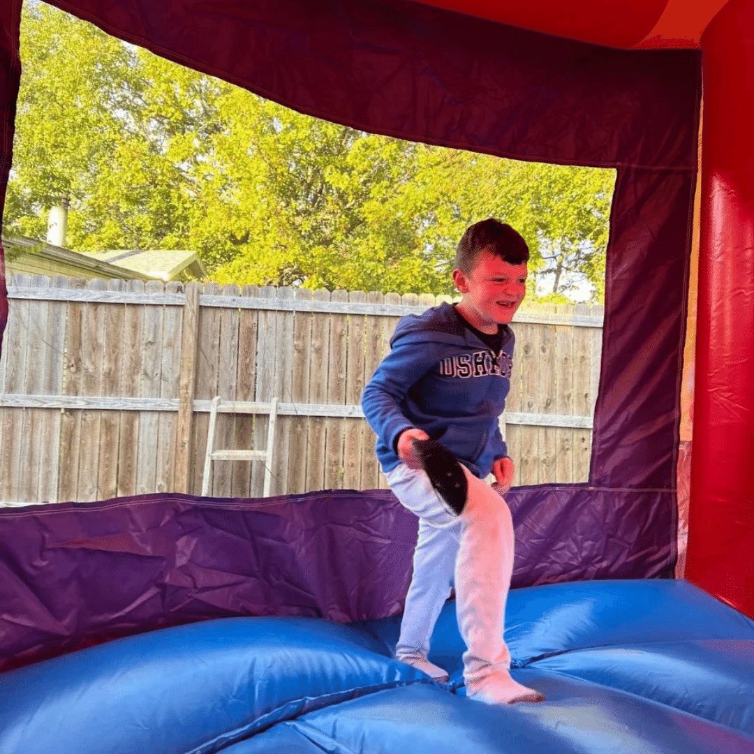 Landon with autism having a great time in his new bounce house