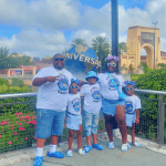 Akirij with autism and his family in front of a fountain in Universal Studios