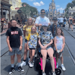 Angelo and his family in front of Cinderella's Castle in Disney World