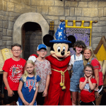 Angelo and his family with Mickey Mouse in Disney World