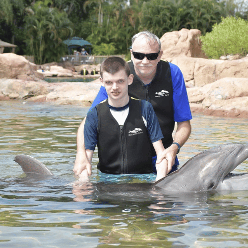 Joshua swimming with the dolphins at SeaWorld