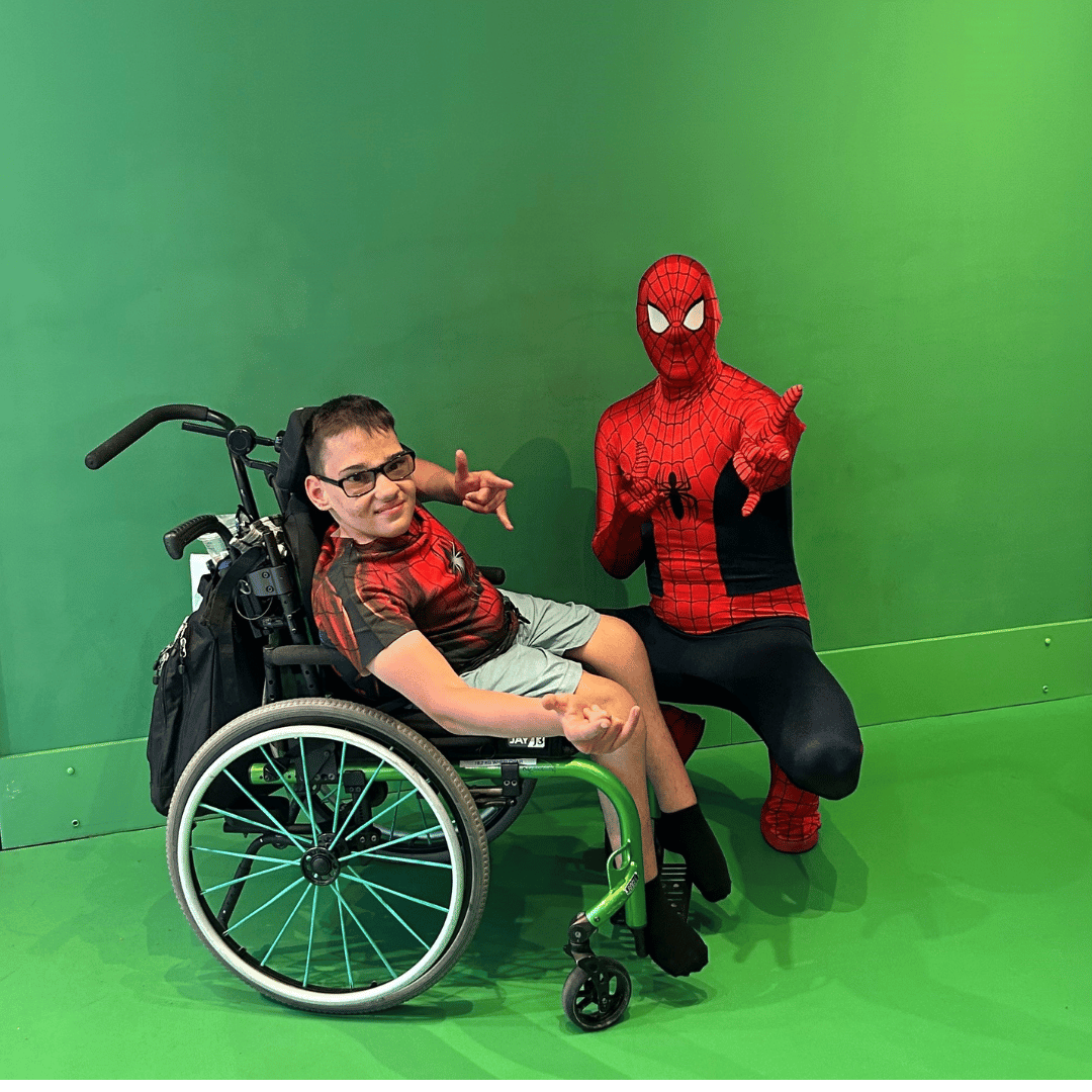 Milen with spina bifida having fun with spiderman